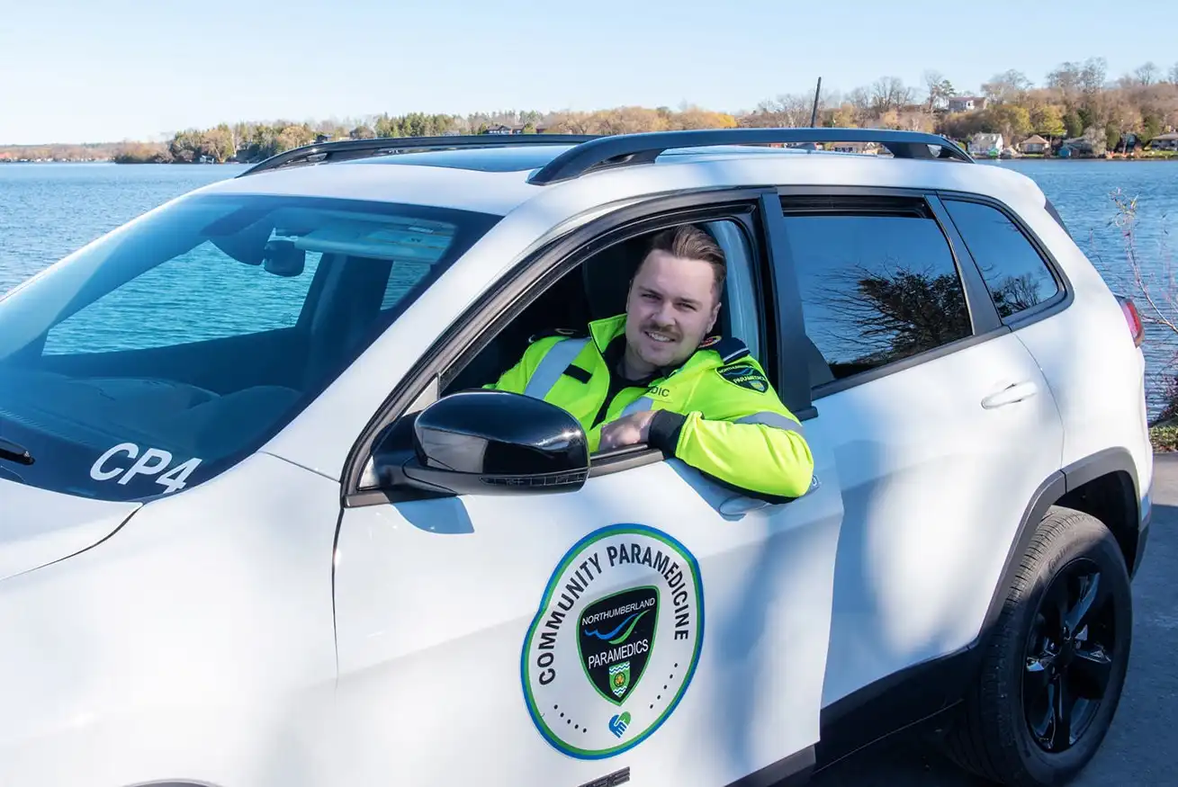 Community Paramedic smiles from window of vehicle