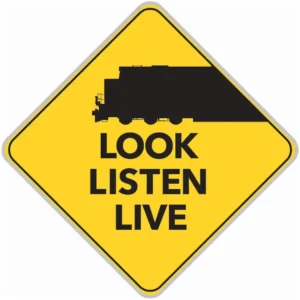 Sign with a train that reads "look, Listen, Live." 