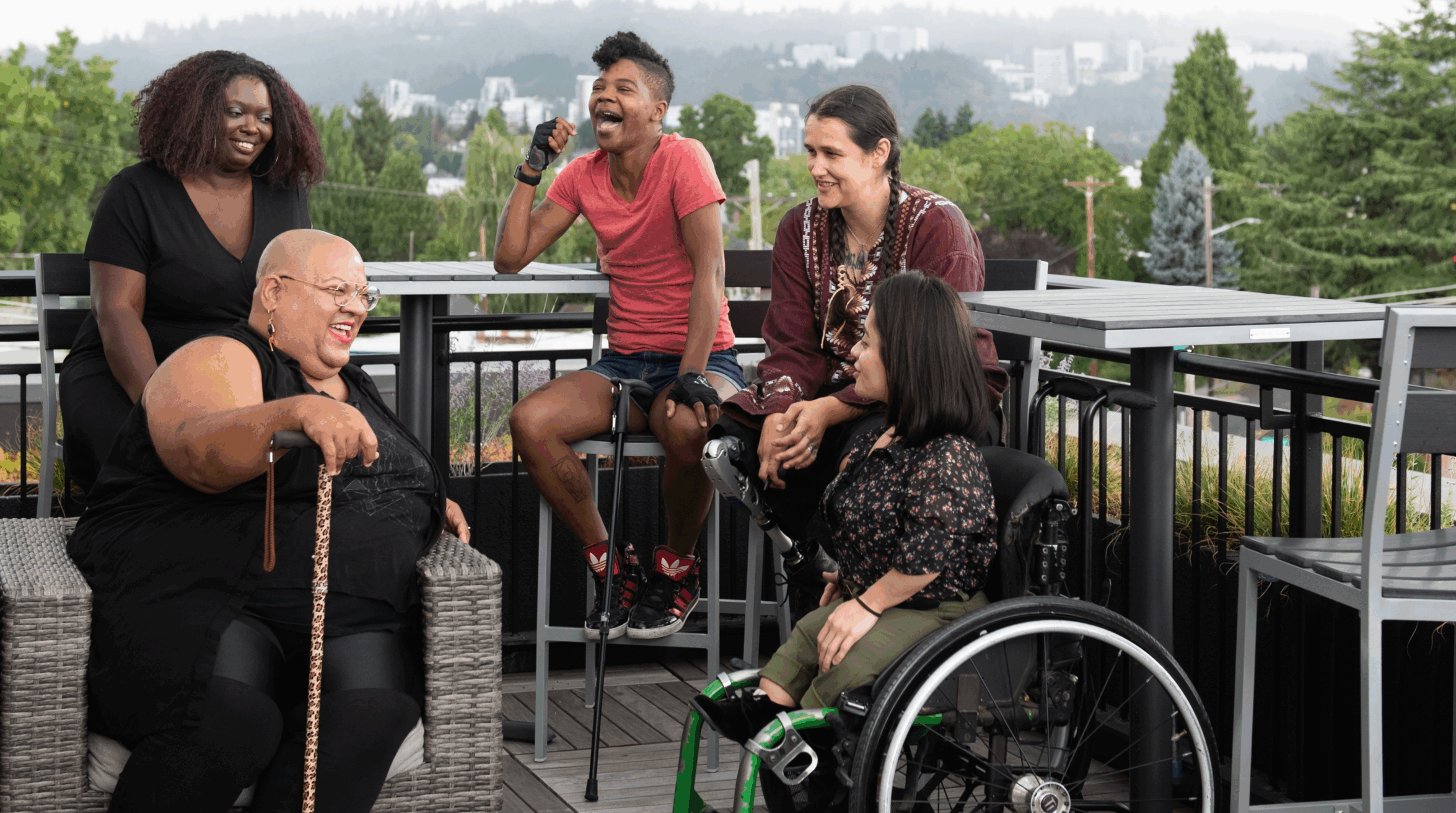 A group of diverse individuals chat and laugh