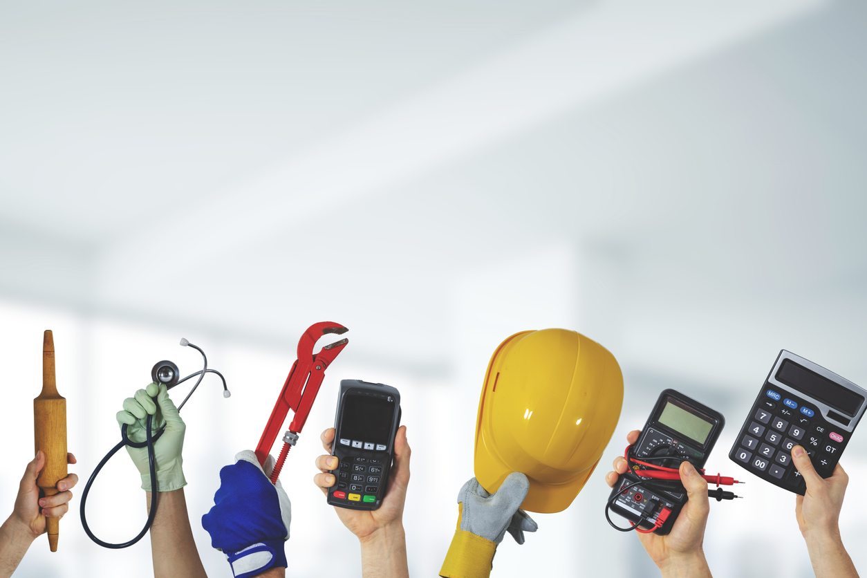hands holding up job tools and equipment