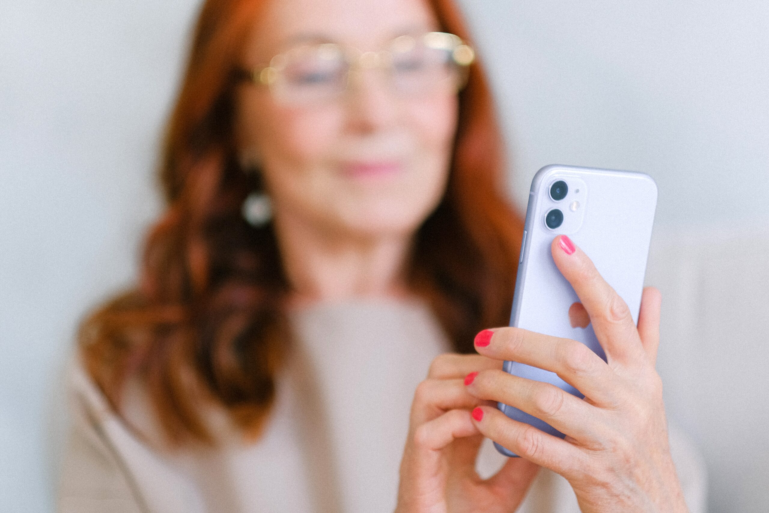 Women holding a mobile phone.