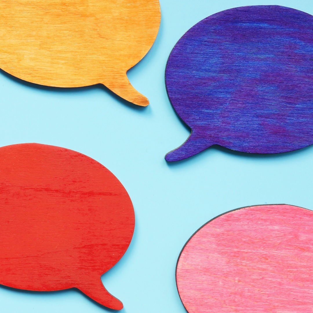 Speech bubbles of various colours on a light blue background.