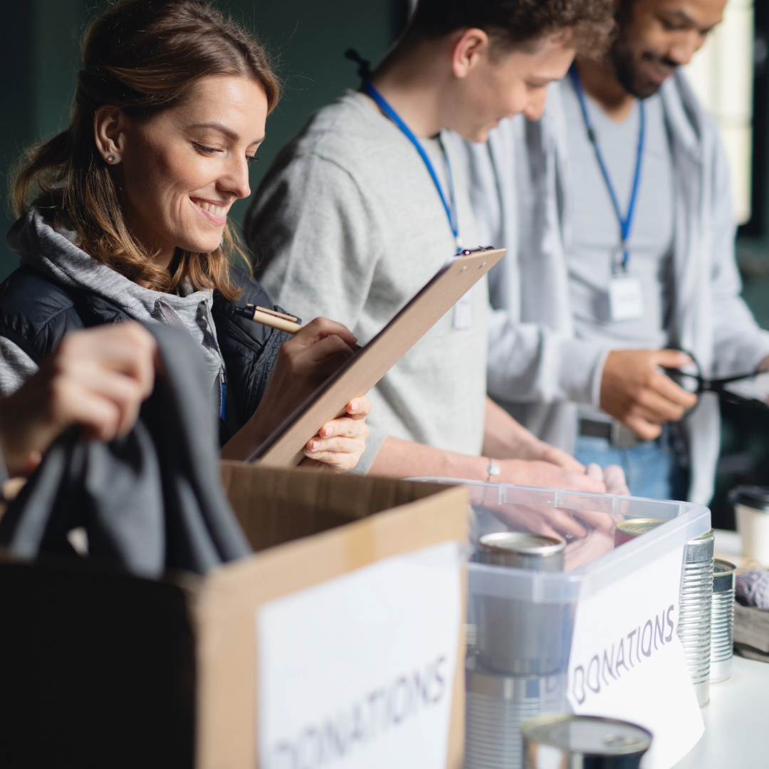 Volunteers sorting donations into boxes.