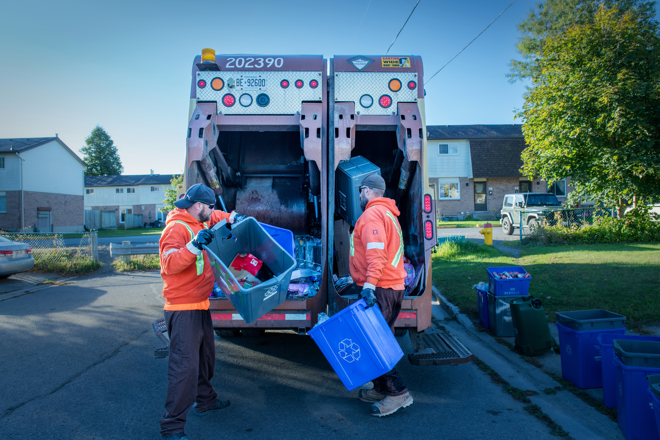 Two staff collecting recycling.