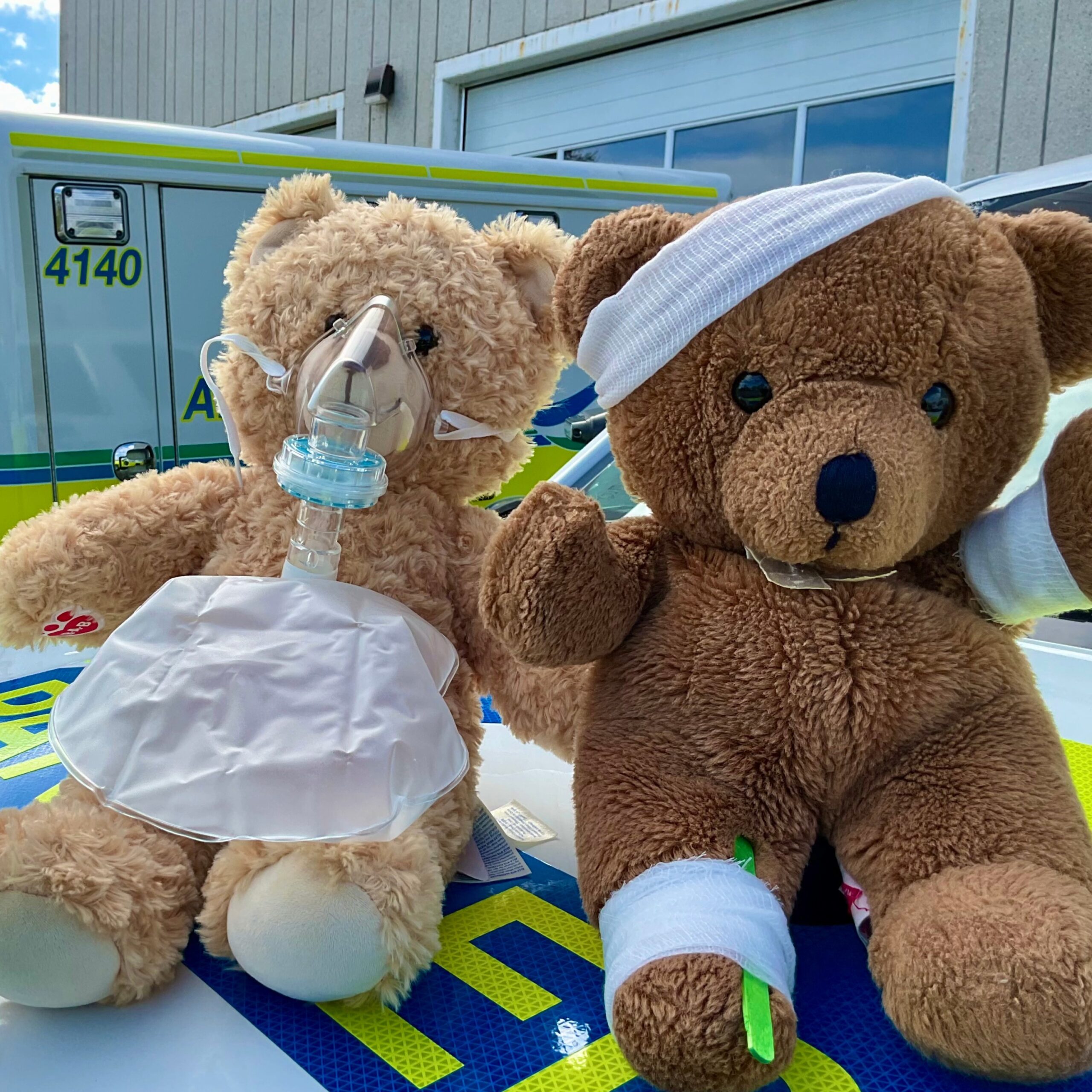Two teddy bears with bandages and other first-aid supplies sitting on an ambulance. Text reads: Paramedic Services Week. Cobourg Farmers Market. Saturday, May 23. 8 AM to 1 PM." The Northumberland Paramedic and EarlyON logos are in the lower left corner.