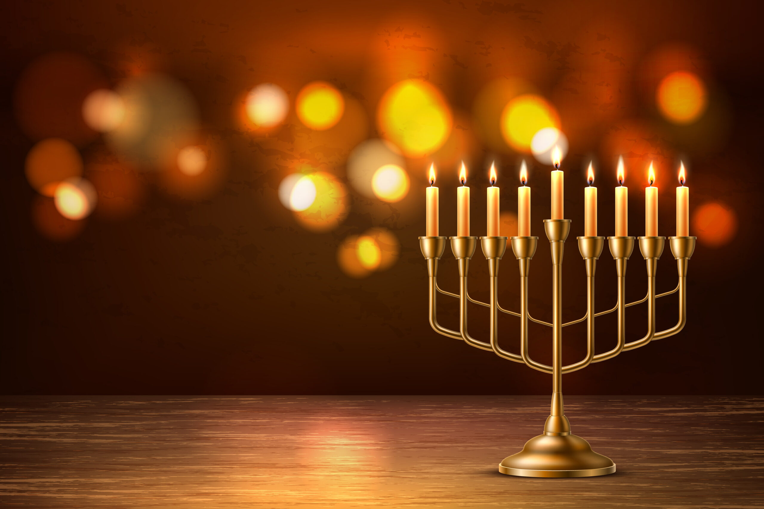 Menorah with candles lit behind it.