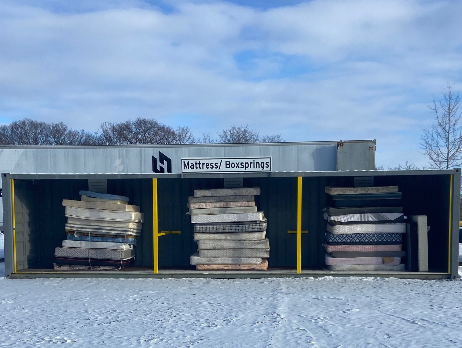 Stack of recycled mattresses at landfill