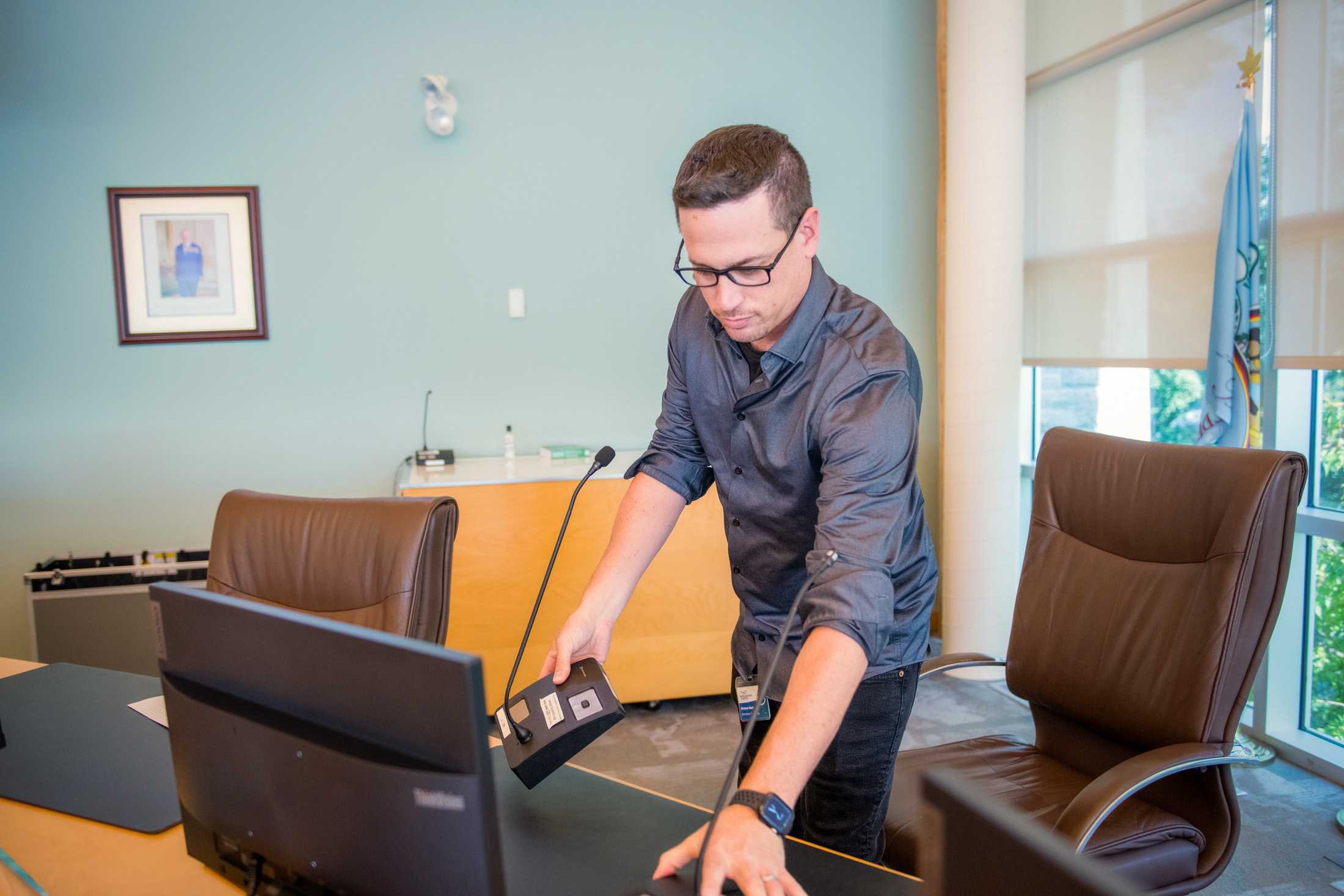 IT staff sets up mic in council chambers