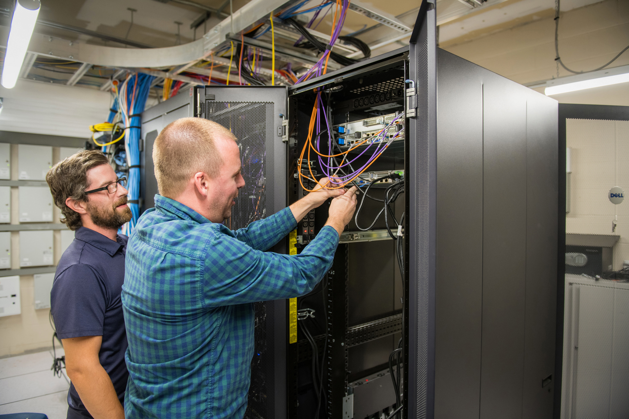 Two IT staff work on IT infrastructure