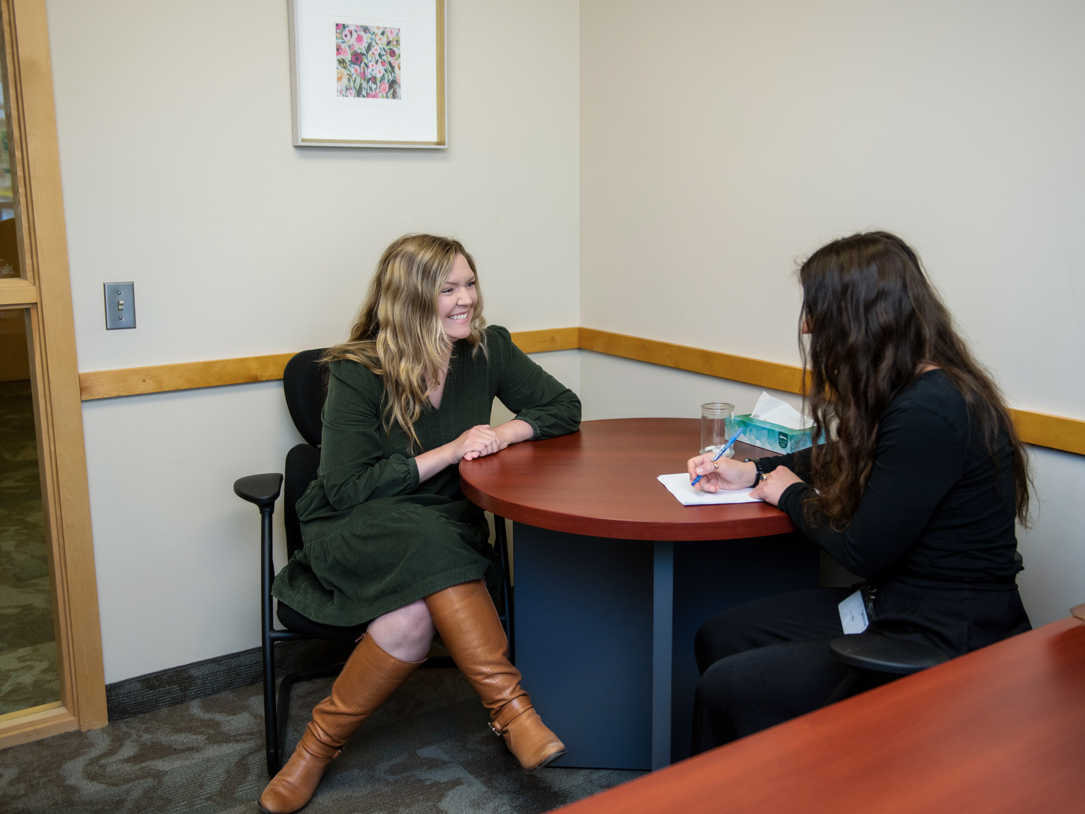 HR staff chats with staff at a table