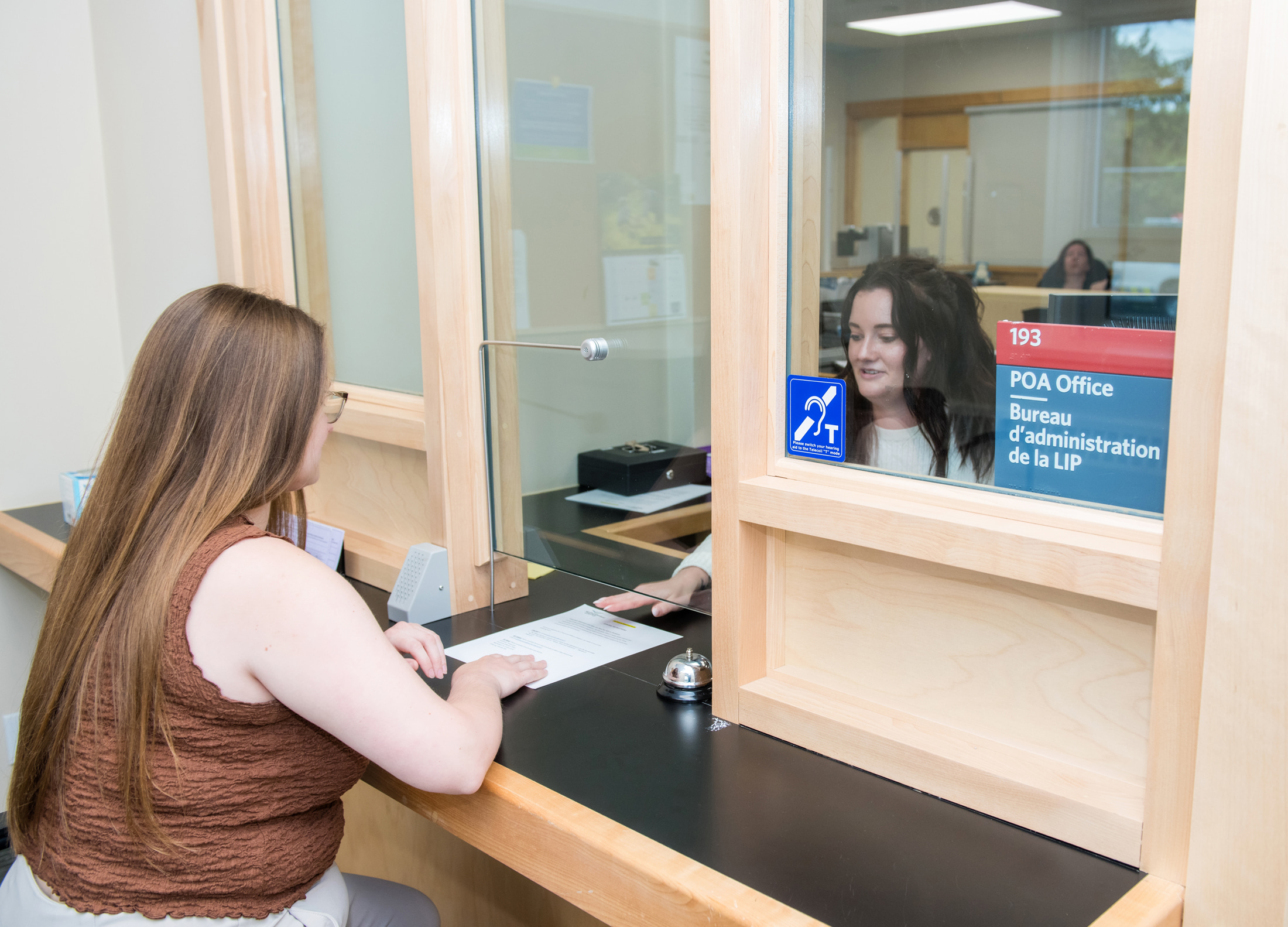 Court Services staff passes paper to client