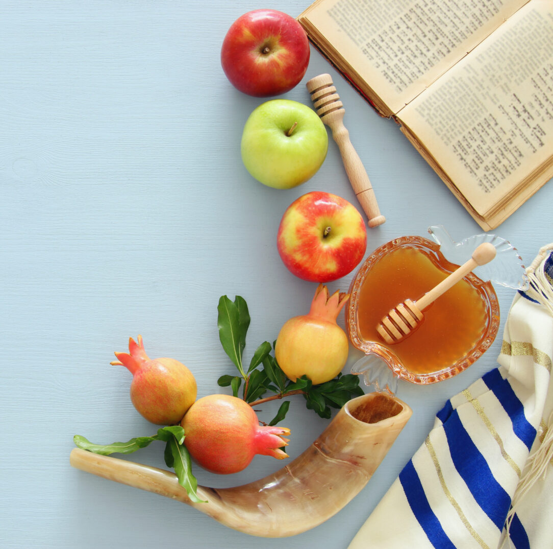 Traditional items placed on a table including apples and honey.
