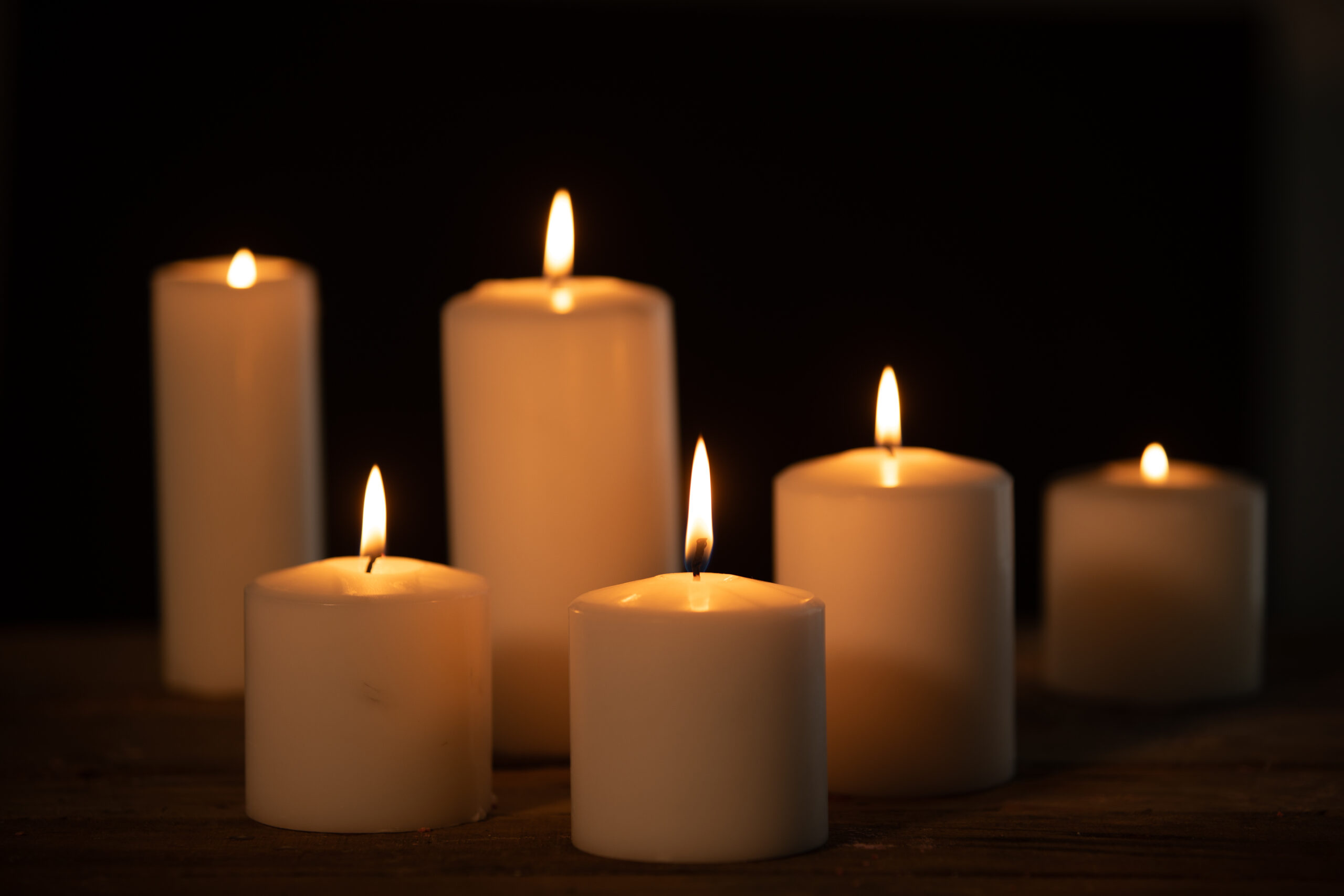 Candles burning on a dark background.