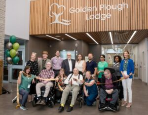 GPL and County staff alongside elected officials and residents. in the foyer of the new building. 