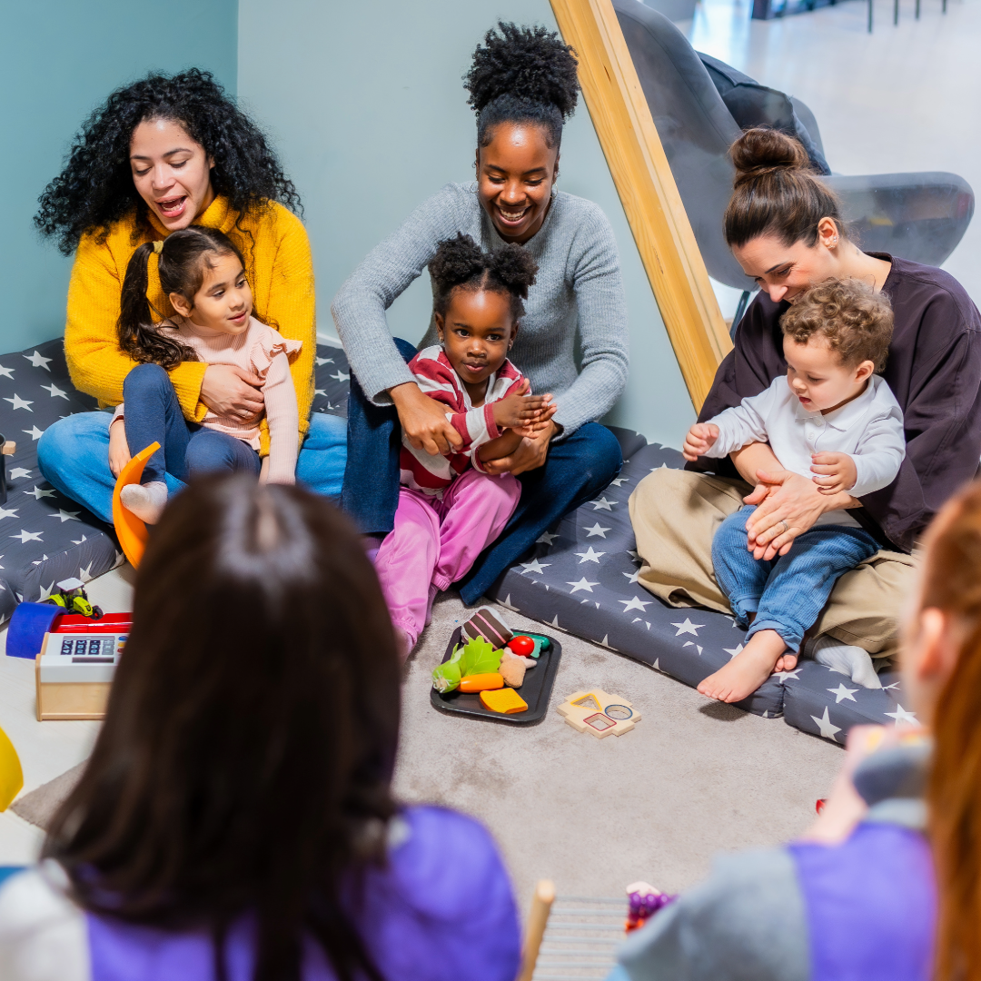 Children and families sitting in a circle at a childcare centre.